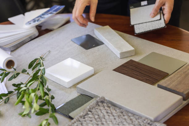 Designer Laying Out A Sample Board For Client In Design Studio
